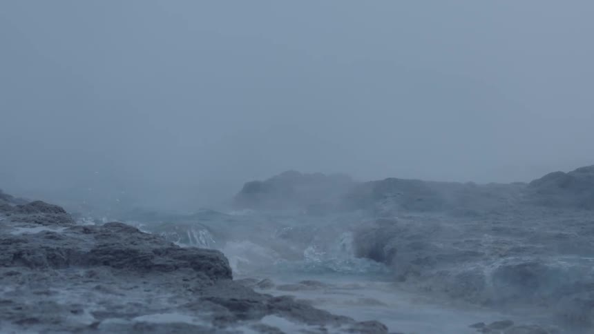 Waves crash onto the rocky shore