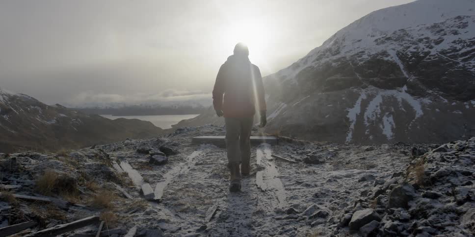 A man walks over a rocky path