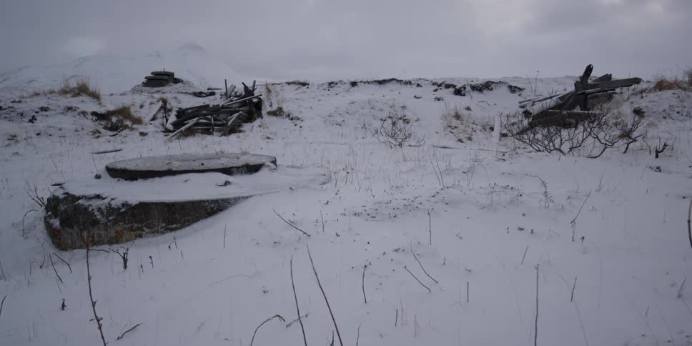 Snow covers a rural landscape