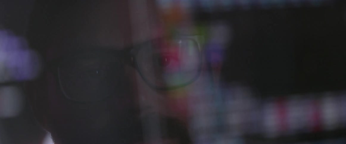 A man looks at computer code on a screen