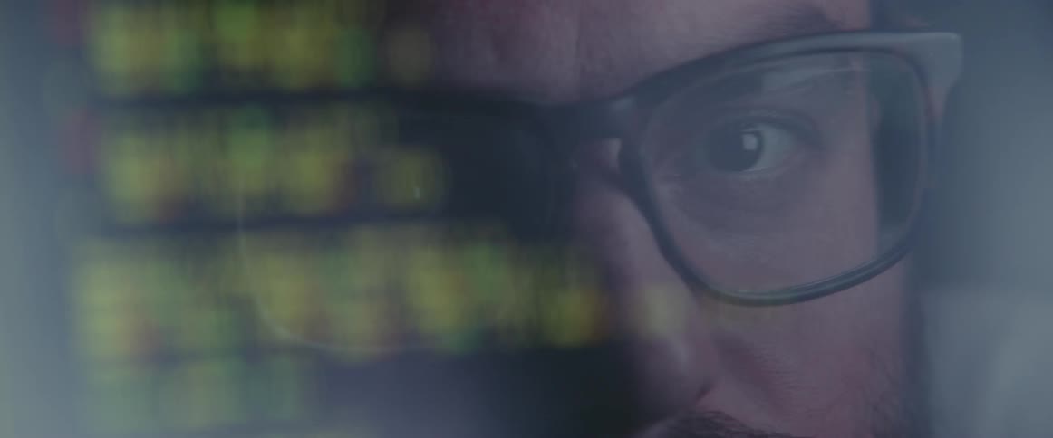 A man looks at computer code on a screen