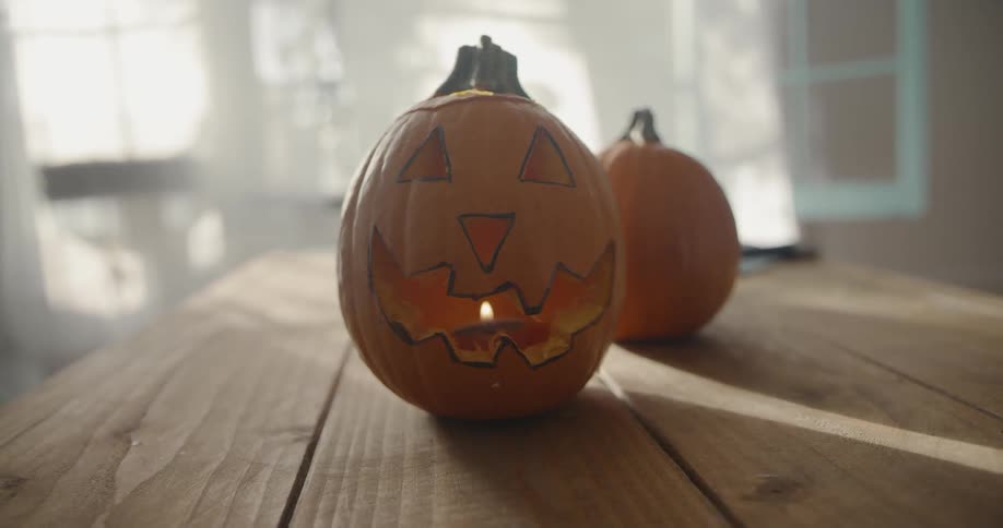 A candle burns inside a carved pumpkin