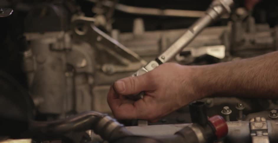 A man is working on an engine