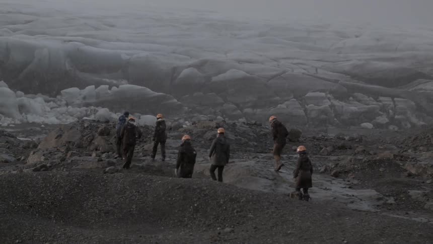 Hikers while in mountains while it snows