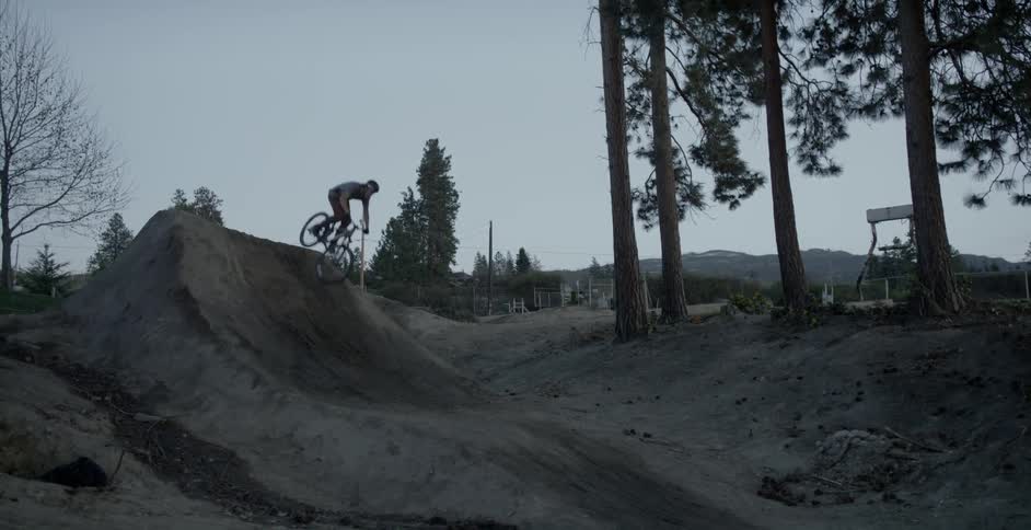 A bicyclist goes over a jump