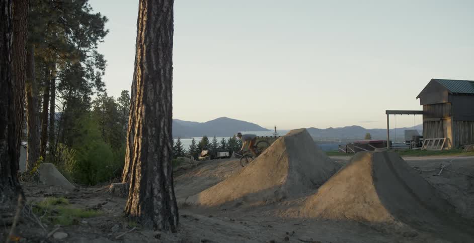 Mountain biker does no hander at sunset