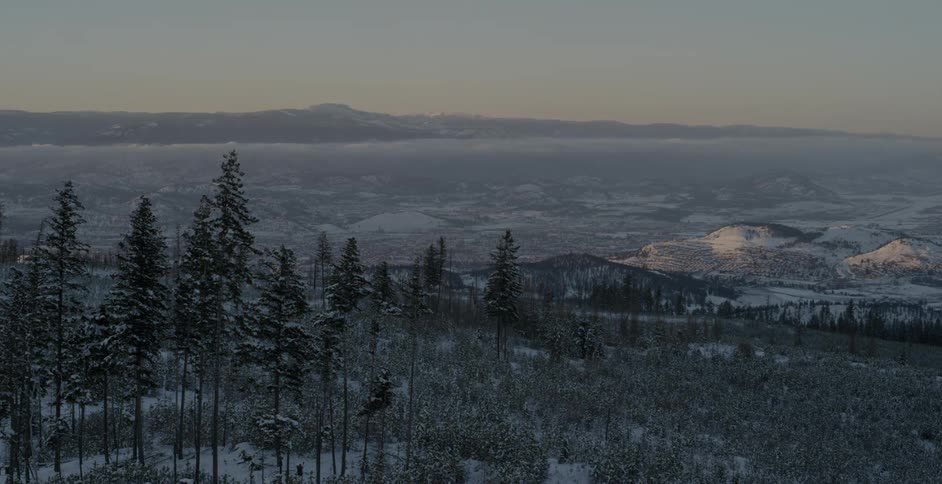 The sun sets over a snowy landscape