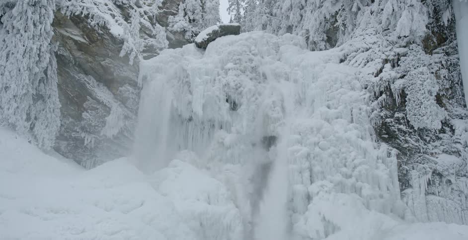 Snow and ice fall off a cliff
