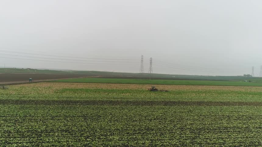 A tractor plows a rural field