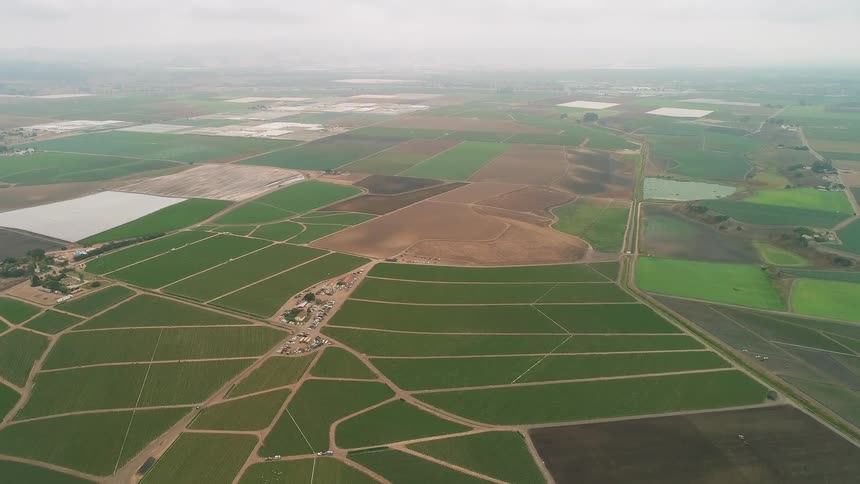 Farm fields cover the ground below
