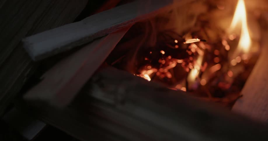 A campfire burns at night