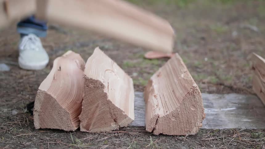 A man throws fire wood on the ground