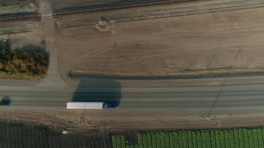Trucks are driving down the road below