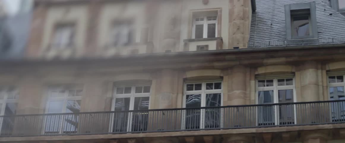 The building has a balcony and many windows