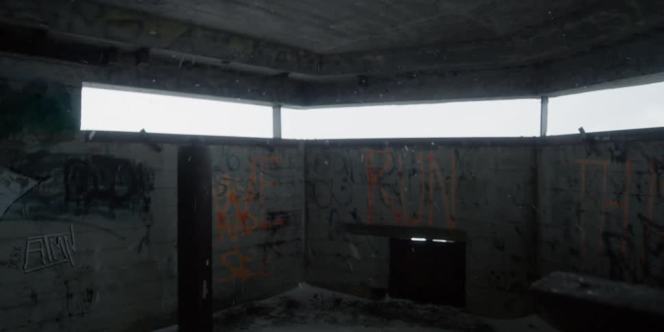 Snow filters through lookout windows in a concrete tower