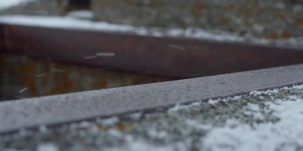 Snow falls on cement ledges