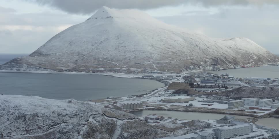 Snowy mountains surround a seaside town