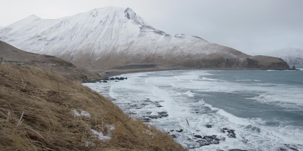 Waves rolling onto an icy beach
