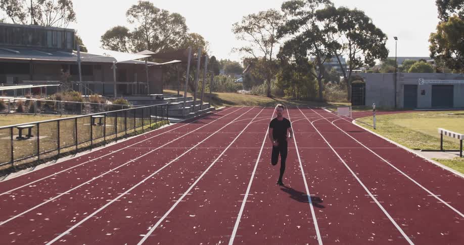 A man is racing down the track