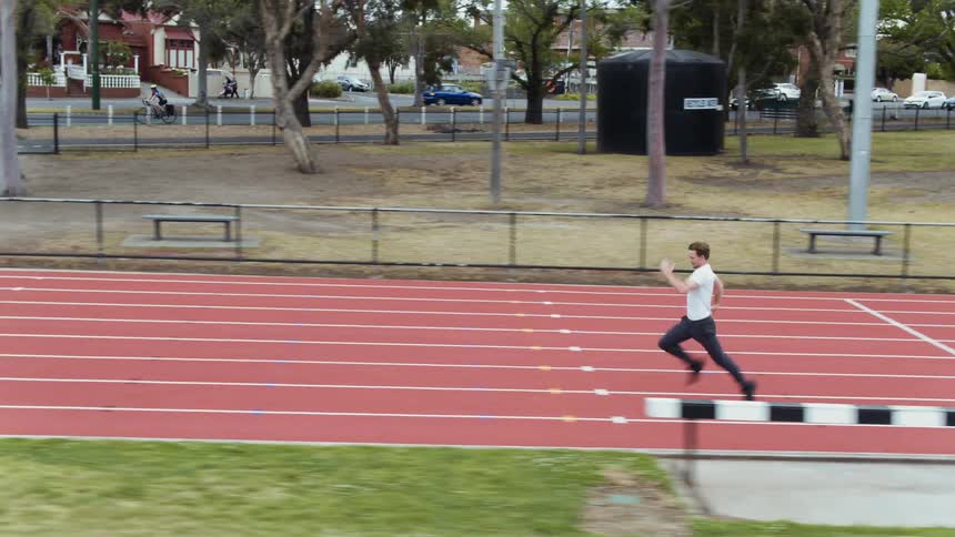 A man jumps up and down before racing