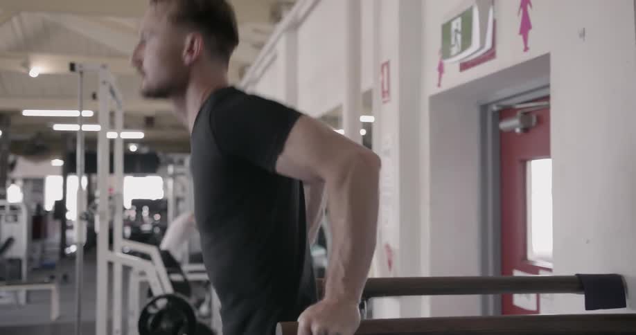 A man exercises on gym equipment