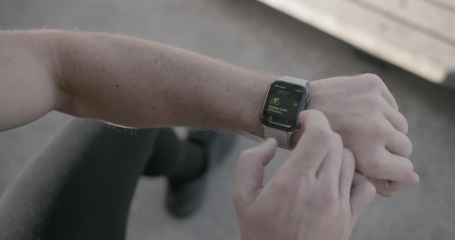 A man uses his watch sitting down