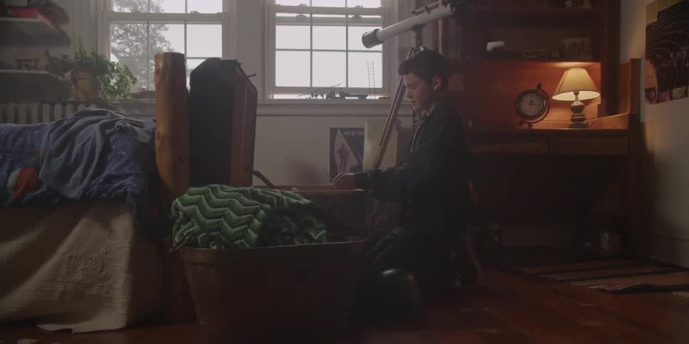 A kid looking through a toy chest