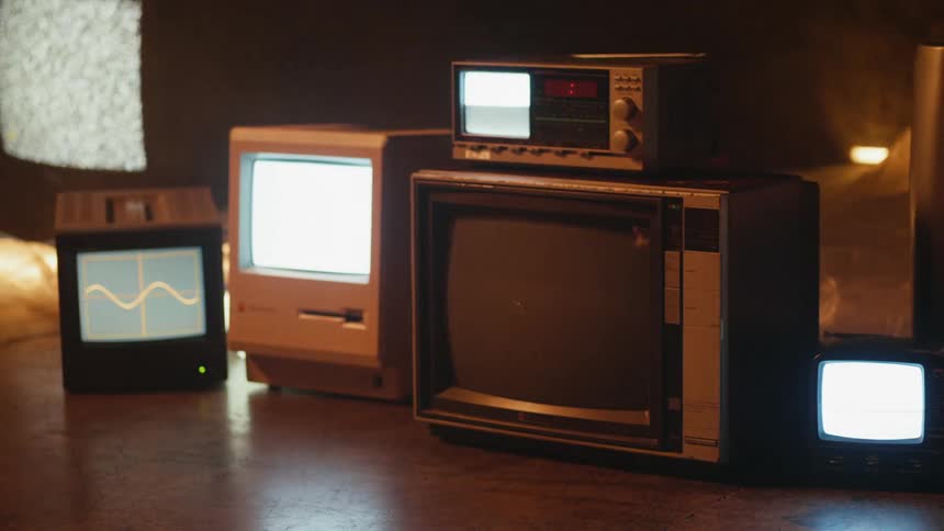 There are televisions stacked all over the ground