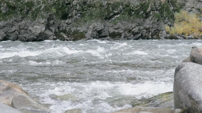 River water flows by rocks