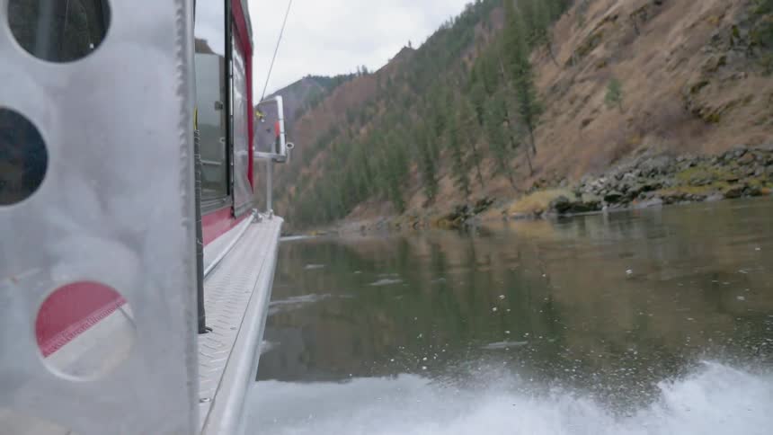 The boat sails near the shore