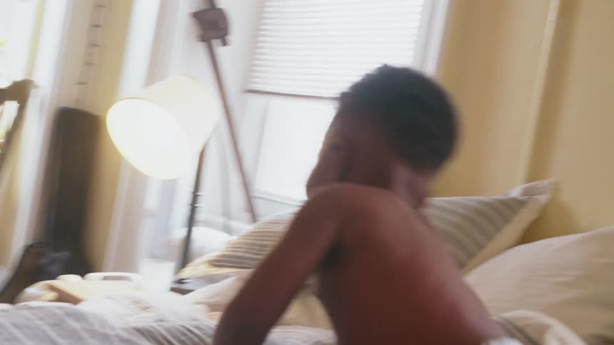 A child runs down the hall to wake his parent