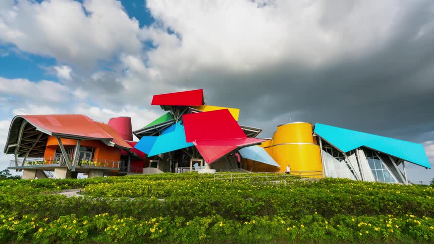 People walk past the large colorful building