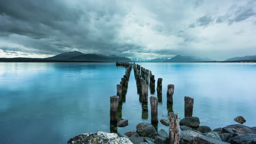The pier is broken with only logs in the water