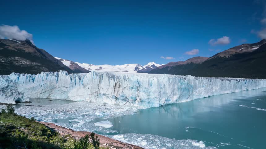 Chunks of ice float away from an iceberg