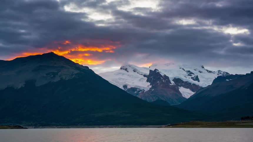 The water leads to a mountain range ahead