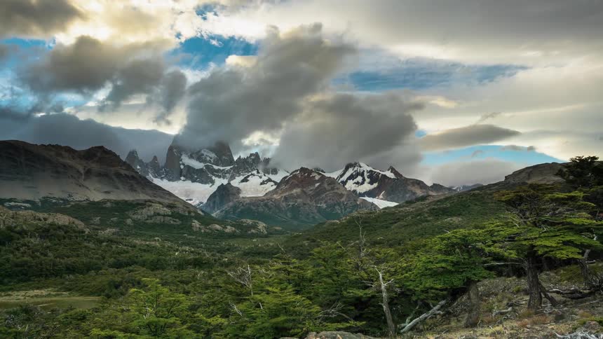 The clouds are rolling over the very top of the mountain