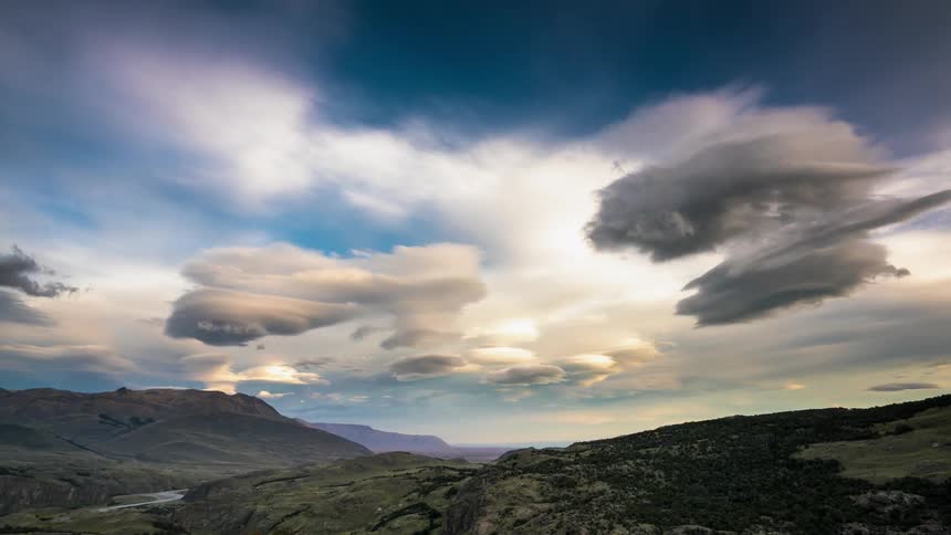 The clouds move fast over the mountain range