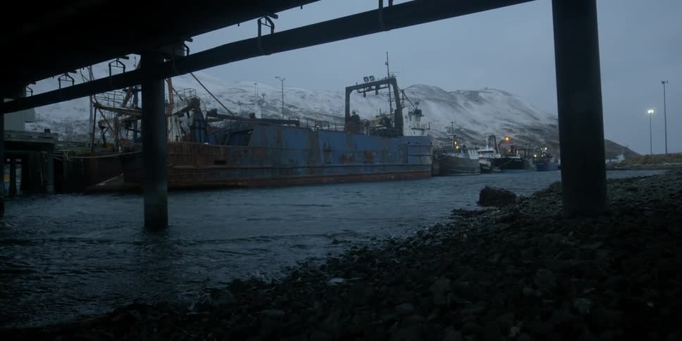 A ship is harbored at a winter pier