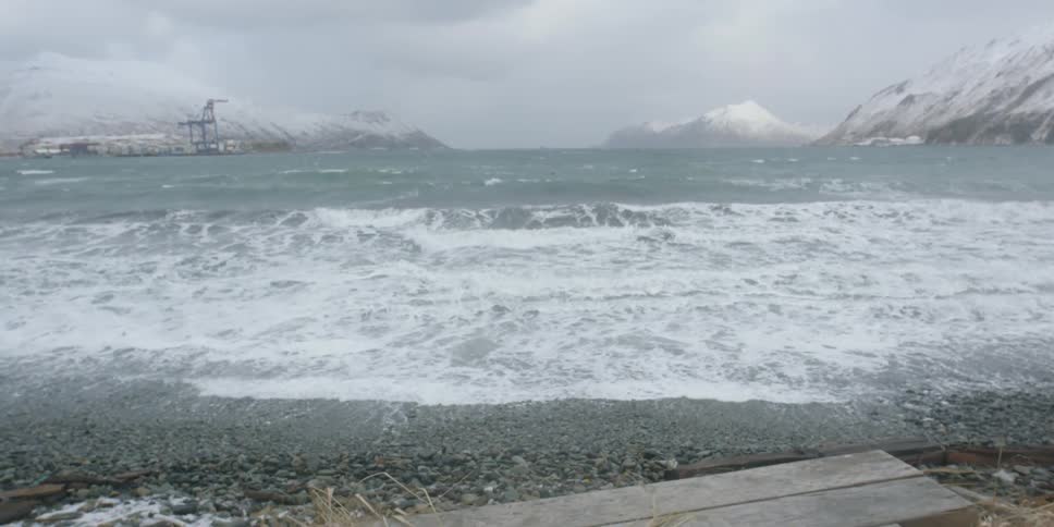 The water is very rough by the winter shore