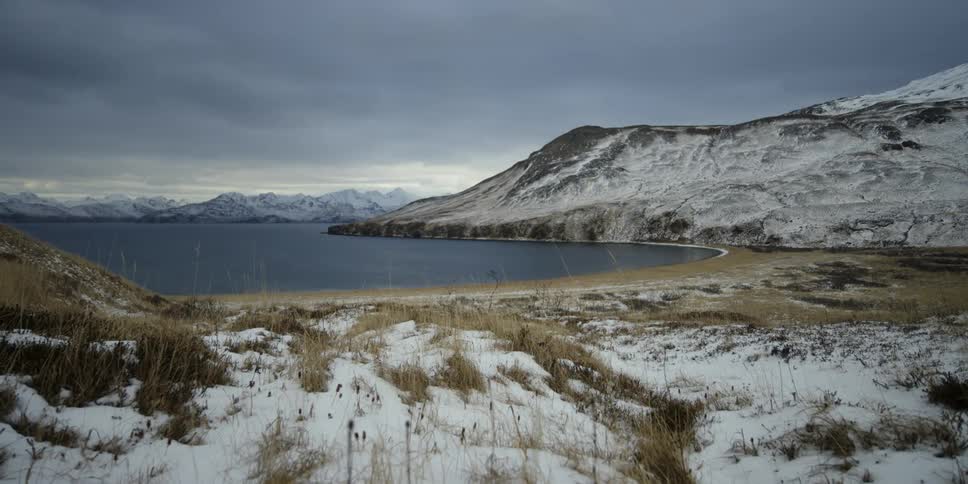 Snowy mountains surround the sea