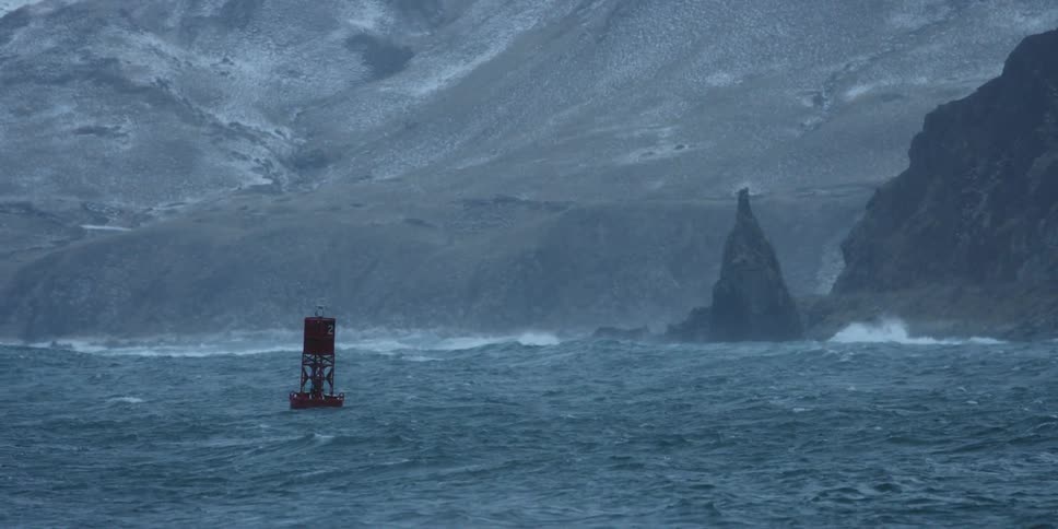 A buoy bobs on the ocean waves