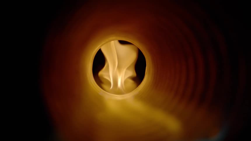 Flame burns through dark tube