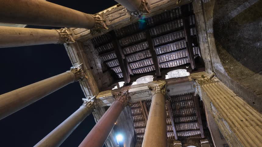 A building with pillars towers overhead