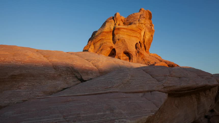 A shadow covers a desert rock formation