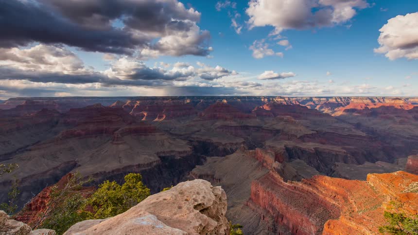Clouds pass above a large canyon