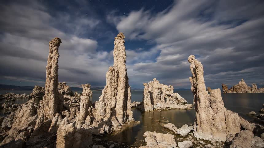 Clouds move over rock formations along the coast