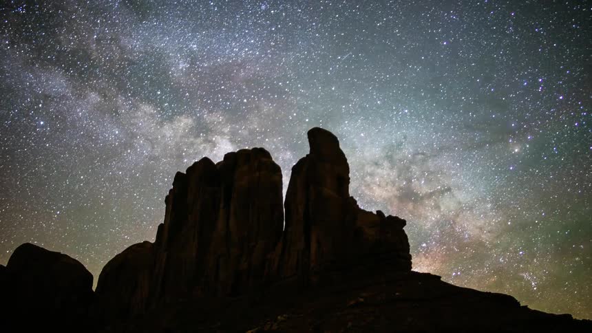 The stars light up the sky above a rock formation
