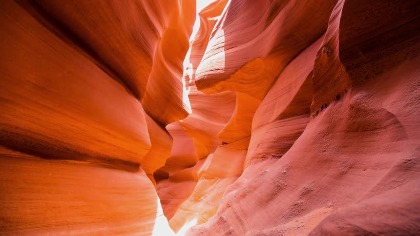 The sun is shining in through the tall cavern walls