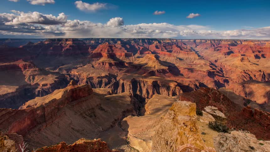 Clouds pass above a large canyon