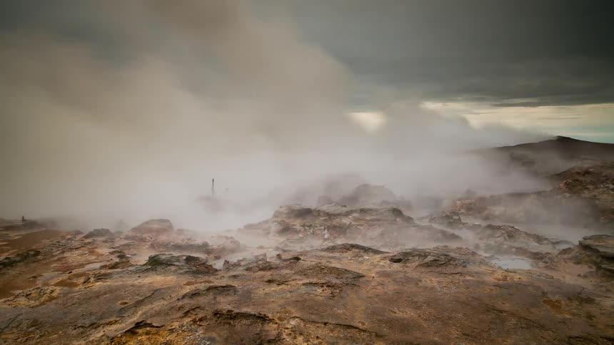 Steam rises from the ground at sunset